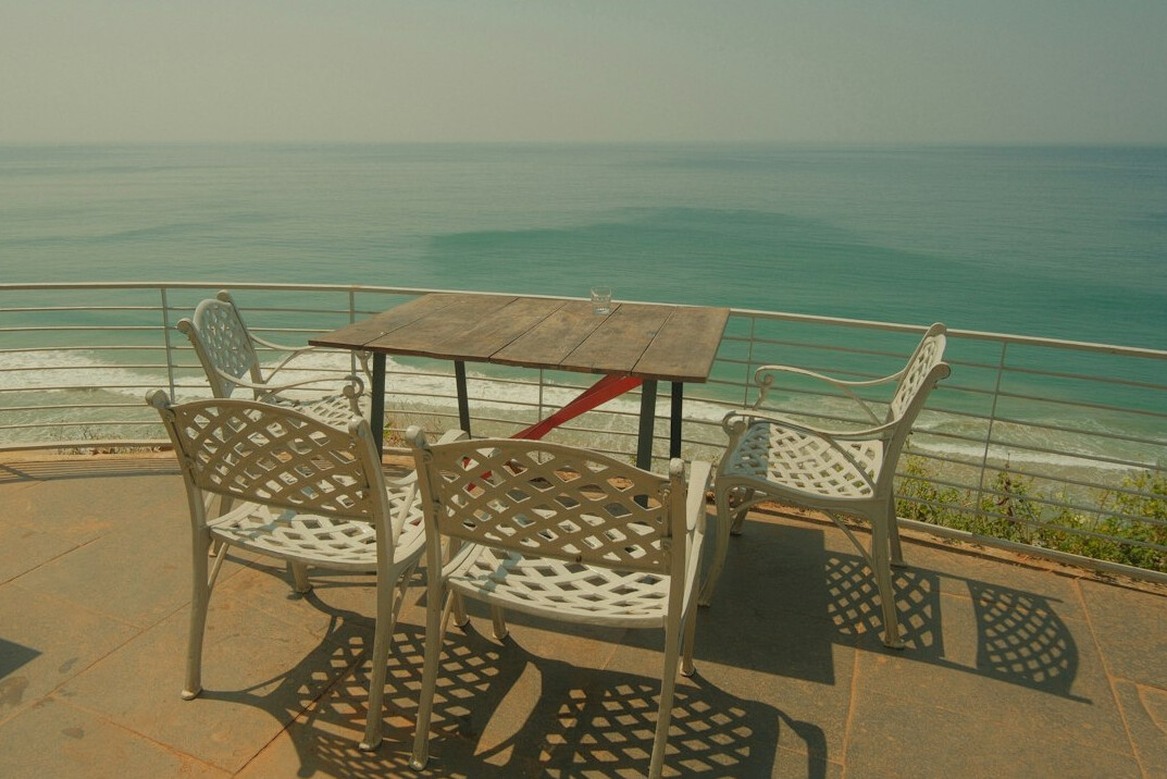 Sunset dinner table set on an oceanfront terrace